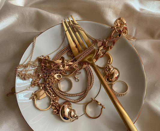 a plate full of 14ct gold jewellery representing a jewellery collection 